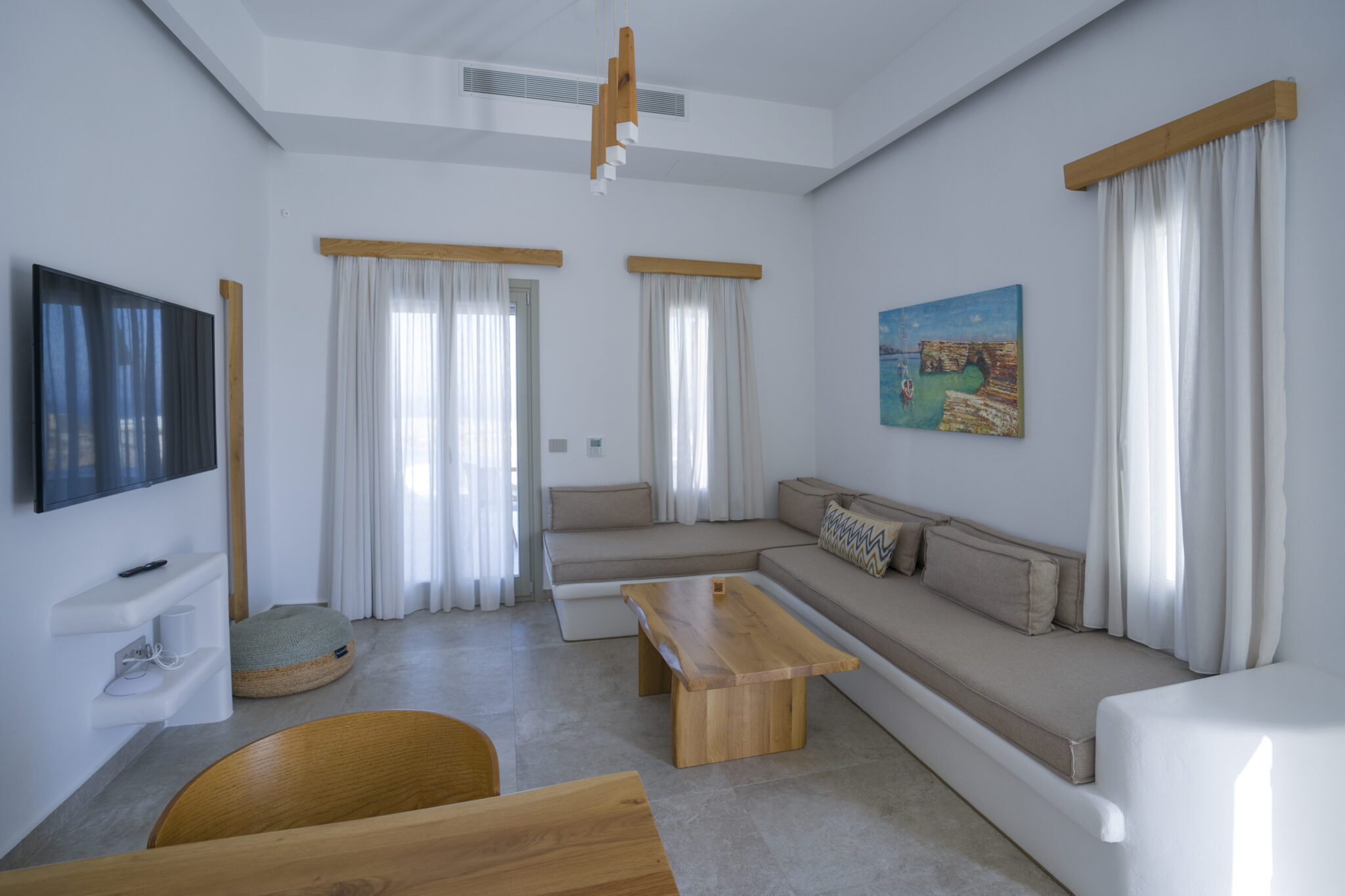 Villa with Semi-private Pool – bright living room with built-in sofa and wooden table