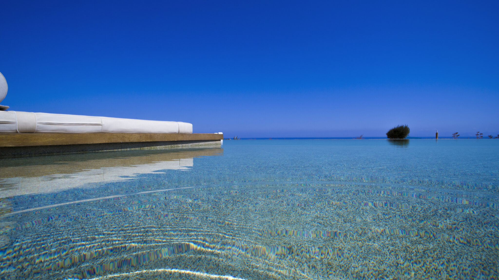 Semi-private infinity pool merging with the Aegean Sea at Aeris Suites Pori